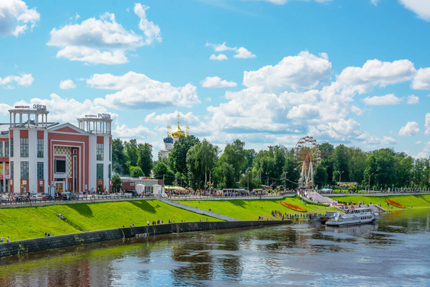 Tver / Russia - July 19 2020: City embankment of the Volga river in the amusement park. In the background there is an Orthodox church. Summer. Lots of green trees. - Photo, Image