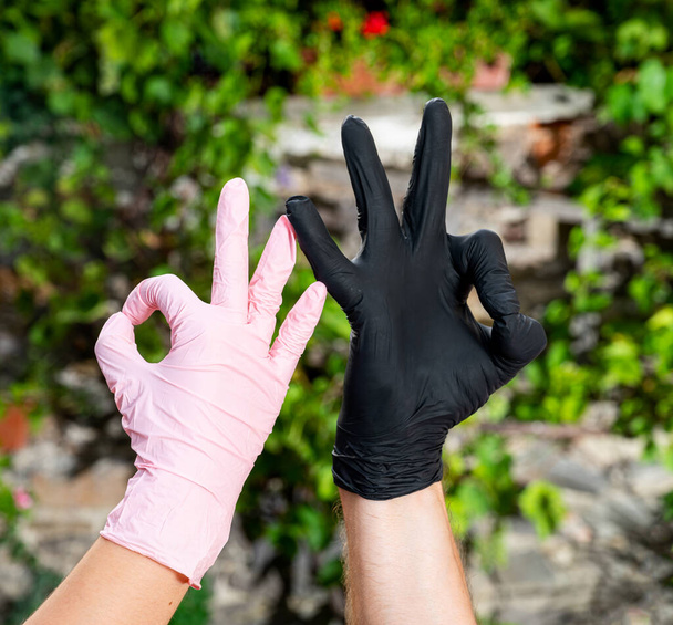 People in protective gloves showing OK sign outdoors - Photo, Image