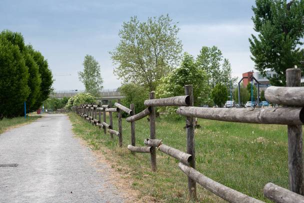The wooden fence around the grass field. The wooden fence near the alpine road. - Fotó, kép