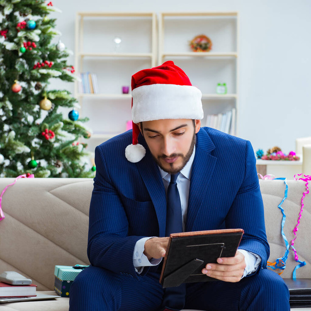 Businessman working at home during christmas - Photo, Image