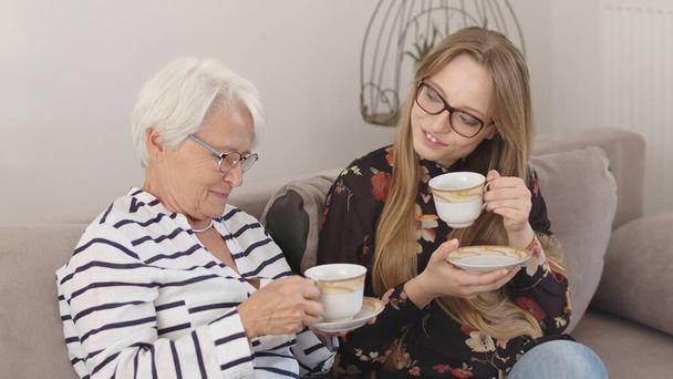 Holidays with family. Mother and daughter or granny and granddaughter having the tea together  - Fotografie, Obrázek