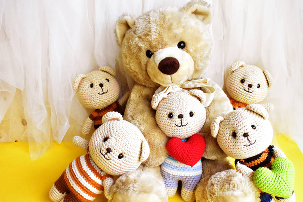 Cute teddy bears family, yellow and white chiffon background, relax, summer holiday, kid toy, childhood memory - Photo, Image