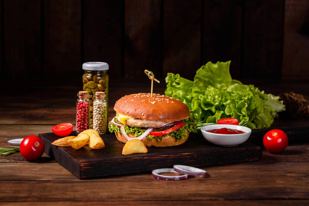 Home made hamburger with lettuce and cheese. Close-up of home made tasty burgers on wooden table - Fotografie, Obrázek