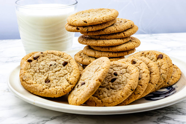 Chocolate chip cookies on a plate with milk. Calgary, Alberta, Canada - Photo, Image