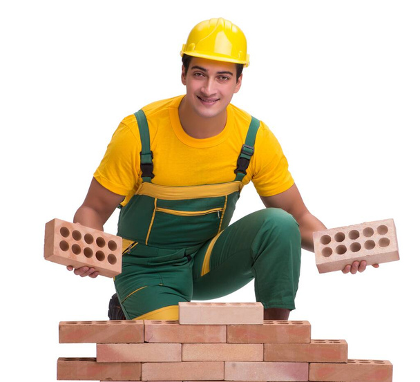 The handsome construction worker building brick wall - Photo, Image