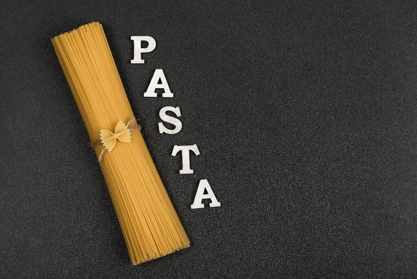 Spaghetti on gray background. Classic Italian spaghetti. Pasta background - Φωτογραφία, εικόνα