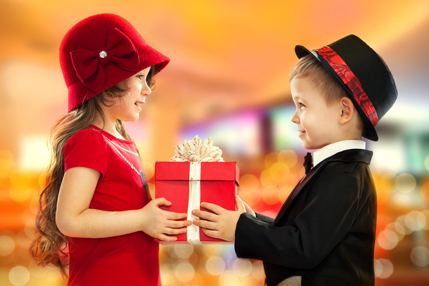 Маленький мальчик дарит девушке подарок
 - Фото, изображение