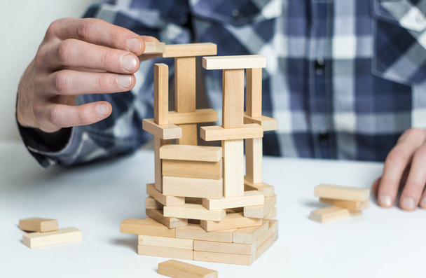 Model of the project of the frame of the house on the table in the hands of the architect. - Foto, Imagem