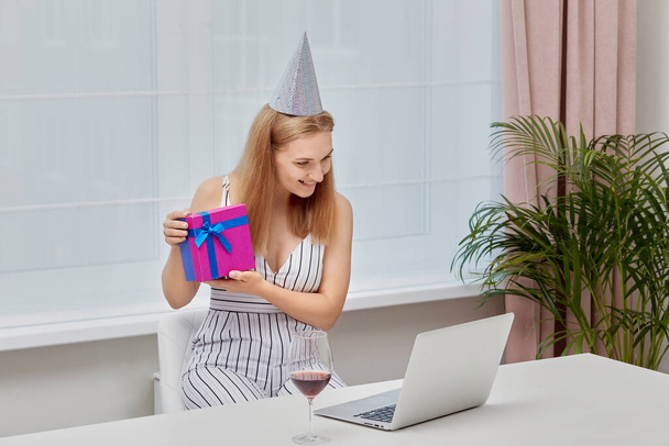 A girl shows a gift that was presented to her for her birthday to the webcam. - Valokuva, kuva