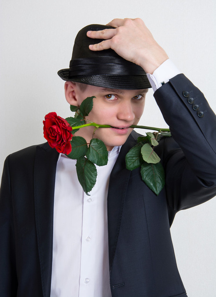 A young man with a rose - Foto, immagini
