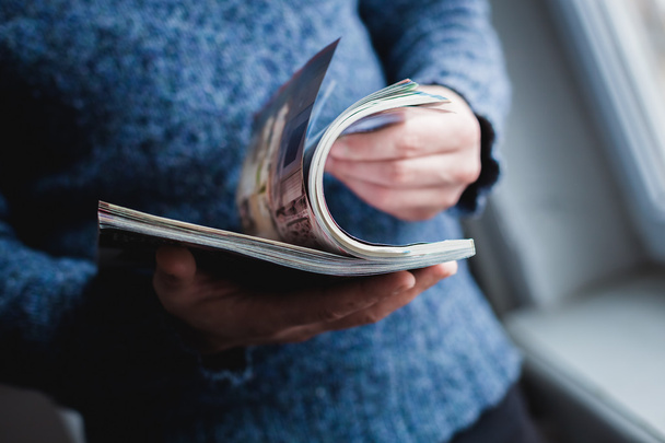 A man looks at a magazine. Press hands. - Foto, Bild