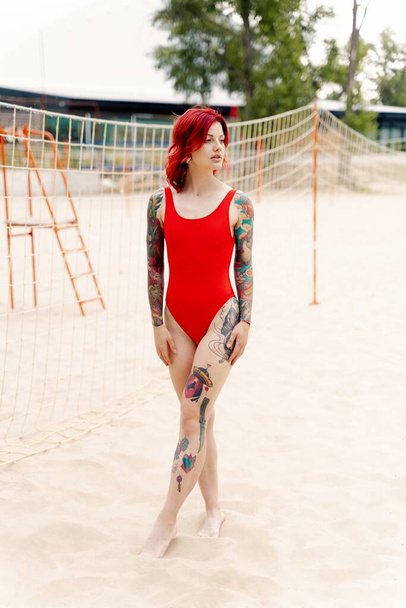 gorgeous young  tattooed woman in swimsuit on the beach  - Fotografie, Obrázek