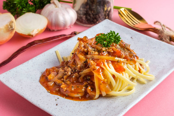 Delicious spaghetti with bolognese sauce served on a white squar - 写真・画像