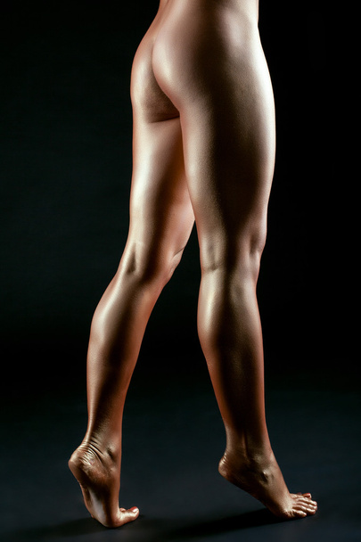 Slender female legs like bronze statue - Zdjęcie, obraz