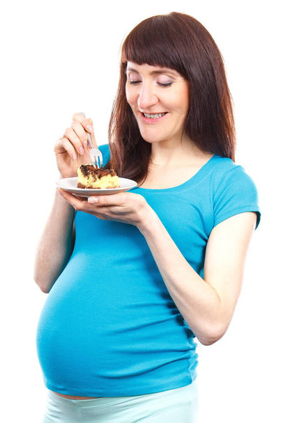 Pregnant woman eating fresh piece of cheesecake, concept of nutrition during pregnancy, expecting for newborn - Foto, Bild