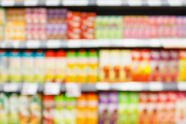 Sfocatura astratta prodotto succo di frutta sano sullo sfondo scaffali del supermercato - Foto, immagini