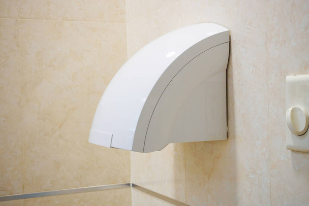 Automatic bathroom hand air dryer in public WC toilet - Fotoğraf, Görsel