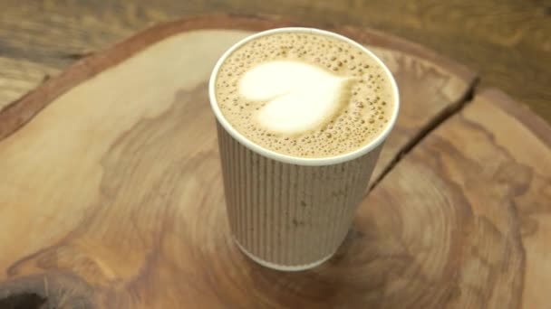 heart latte art paper cup coffee drink on wood board love at first sip - Footage, Video