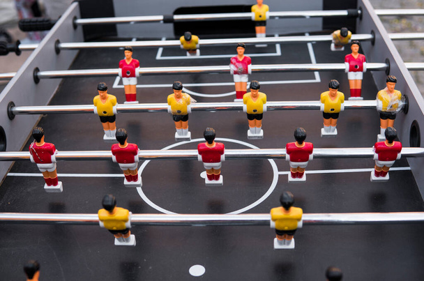 Table football game. Soccer table with red and yellow players. - Фото, изображение