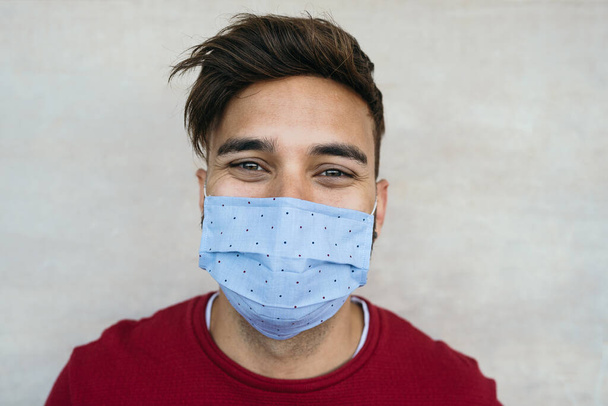 Young man wearing face mask portrait - Latin boy using protective facemask for preventing spread of corona virus - Health care and youth millennial people concept - Zdjęcie, obraz