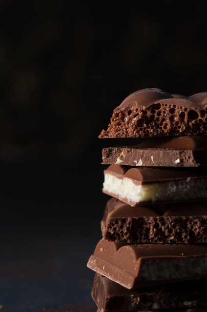 Stack of dark chocolate with cacao powder. - 写真・画像
