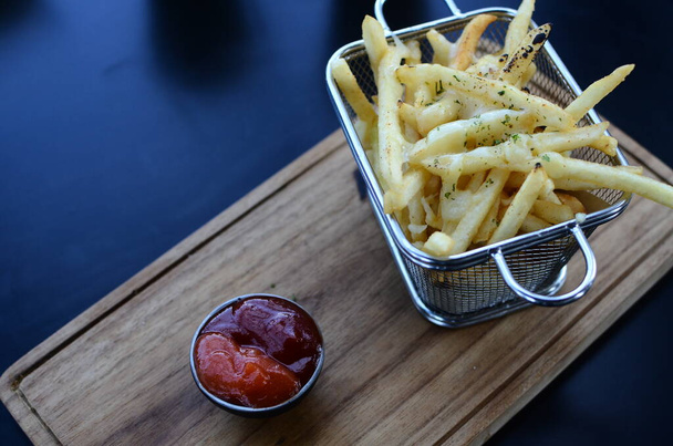 French fries in basket with ketchup and sauce - Foto, Imagen