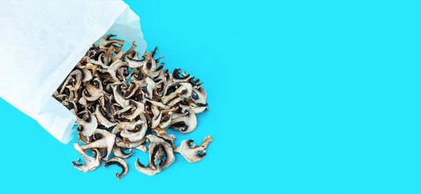 dehydrated dried mushroom slices on a blue background. Vegan and vegetarian food. Flat lay - Photo, Image