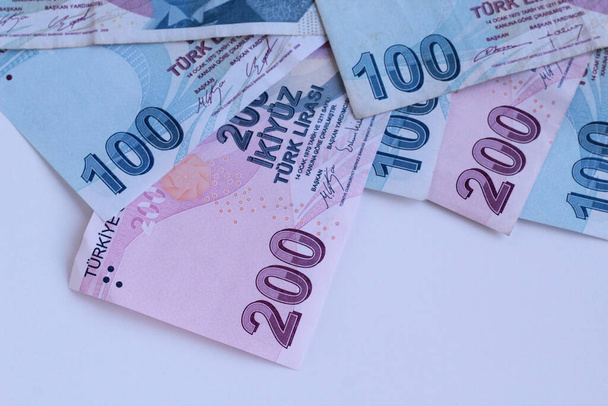 Turkish two hundred and hundred banknotes on white surface with copy space - Photo, Image