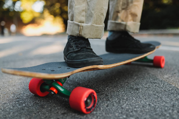 Longboard with red wheels on the asphalt. - Foto, immagini