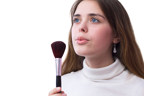 Portrait of a girl blowing on a brush for makeup - Φωτογραφία, εικόνα
