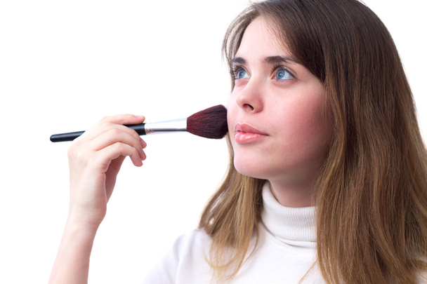 portrait of a girl makes a make-up with brush - Zdjęcie, obraz