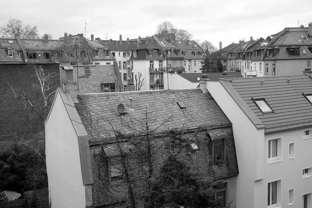 A grayscale shot of rooftops of buildings - Фото, зображення