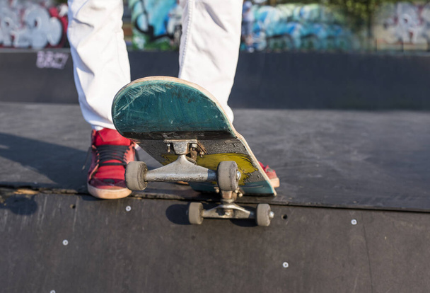 A closeup shot of a male riding a skateboard - Zdjęcie, obraz