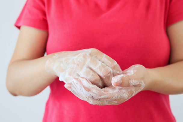Woman washing hands with soap for COVID-19 corona virus prevention concept - Photo, Image