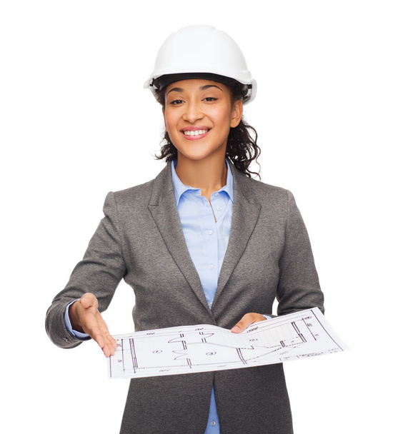 Businesswoman in white helmet with blueprint - Photo, image