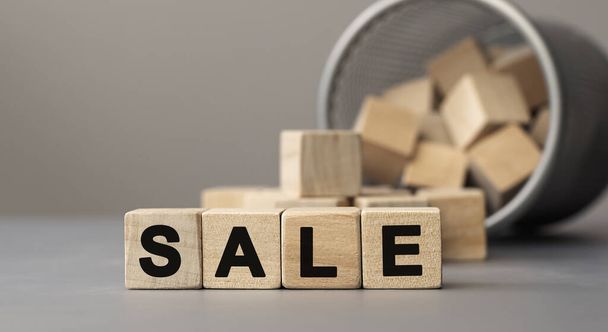 Word SALE made with cube wooden block on a desk. - Zdjęcie, obraz