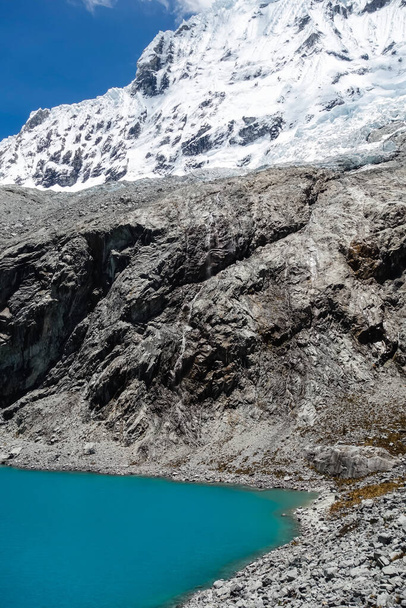 A beautiful shot of a rocky landscape with a lake near the Huascaran mountain in Peru - 写真・画像