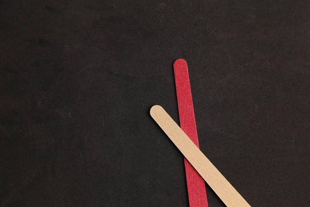 A top view of two wooden nail filers on a black background - Zdjęcie, obraz