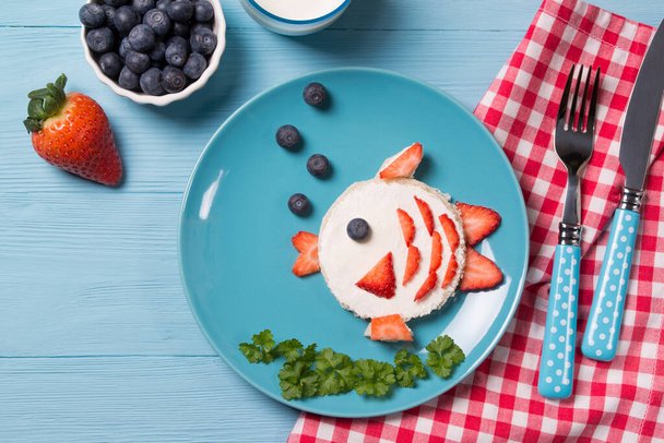 Funny toast in a shape of fish, sandwich with cream cheese and berries, food for kids idea, top view - Photo, Image