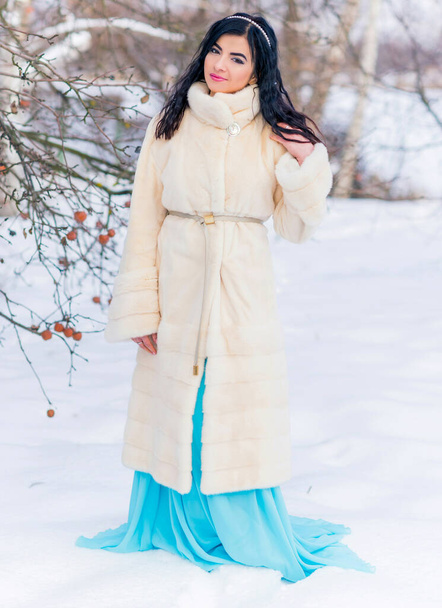 Fashion concept. Beautiful arabic lady in holidays, modern woman wear fur coat look . Fashionable lady outdoors portrait - Photo, image