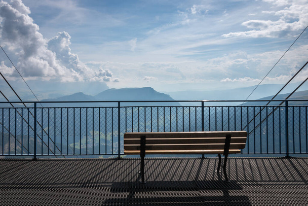 Empty bench on Seceda cable car station in front of Val Gardena, Dolomites, Trentino Alto Adige, South Tyrol, Italy - 写真・画像