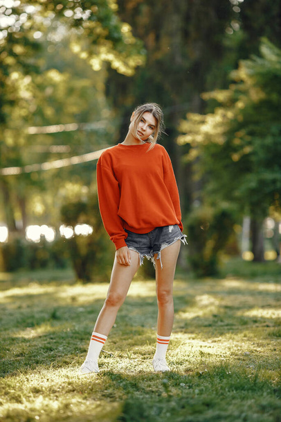 Girl standing in a summer park - Fotó, kép