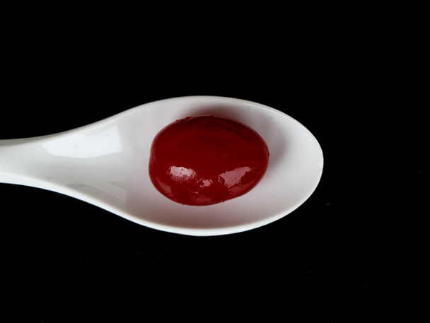 Red color sweet cherry fruits in a white bowl against dark background, with copy space, caption - Photo, Image