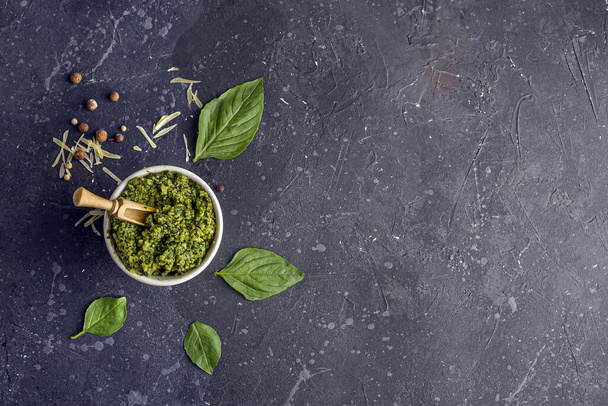 Fresh Cooked Traditiona Italian sauce Pesto and Basil leaves on dark background. Copy sapce for text - Fotoğraf, Görsel