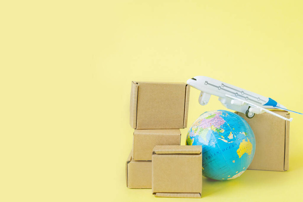 Airplane and stack of cardboard boxes. concept of air cargo and parcels, airmail. Fast delivery of goods and products. Cargo aircraft. Logistics, connection to hard-to-reach places. Banner, copy space - Photo, image
