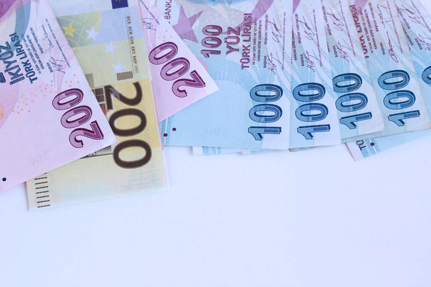 Turkish Banknotes on the light blue surface with two hundred Euro Banknote and copy space,panoramic view - Photo, Image