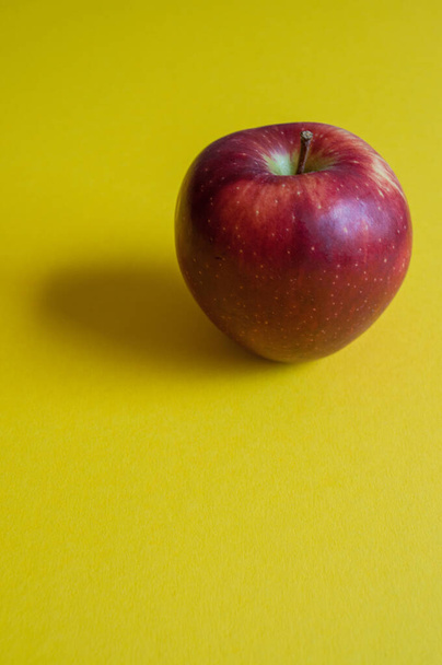Isolated fresh red apple on yellow background.  - Foto, Imagem