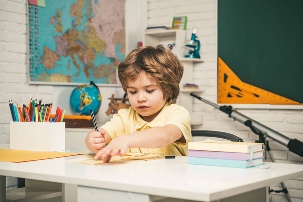 Child near chalkboard in school classroom. First school day. - Foto, Bild