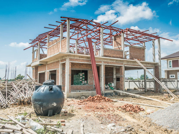 house building structure at construction site with clouds and blue sky - Photo, Image