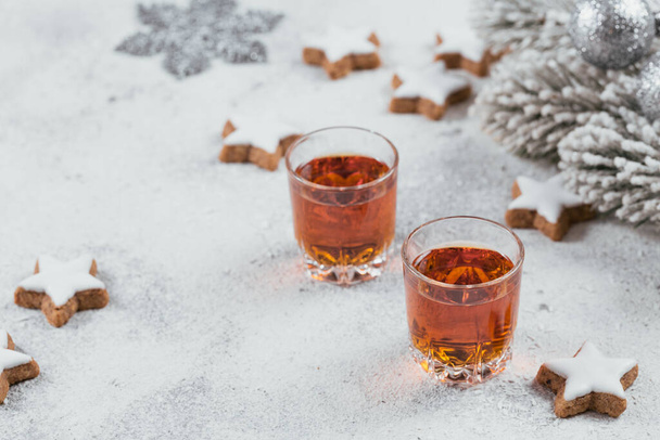 Whiskey, brandy or liquor, cookies and winter holiday decorations on white background. Seasonal holidays concept. - Foto, Imagen